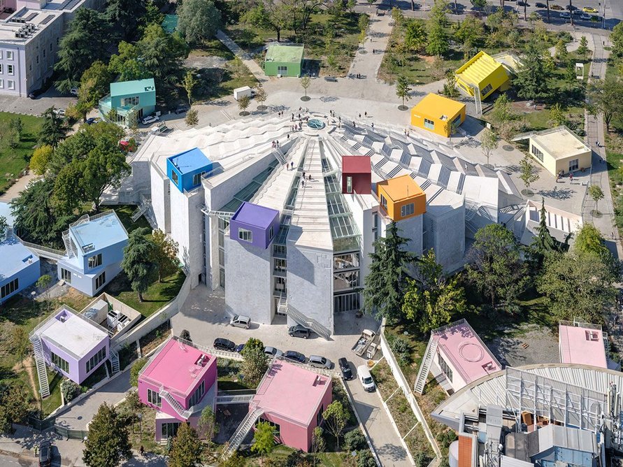 View of MVRDV's renewed Pyramid of Tirana from Downtown One. The coloured boxes revive the building as a youth skills centre.