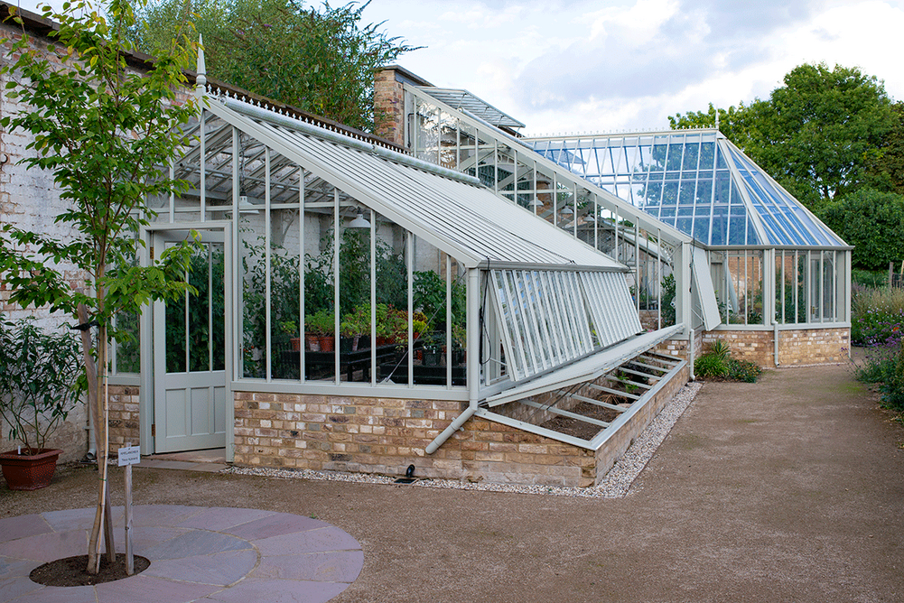 Side profile of the aluminium and brick glasshouse at Ramsey Walled Garden.