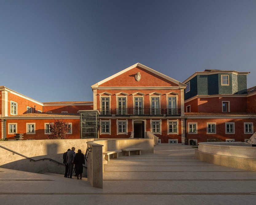 The palace's courtyard facade, with the tile-clad clerestory above the main stairwell to the right.