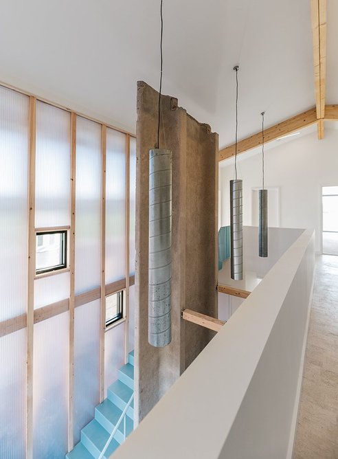 Light filters in to the living space through a polycarbonate wall.