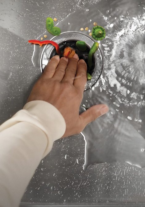 While the water is running, push food waste into the plughole.