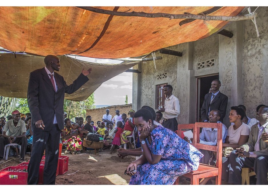 The beneficiary, Rutaganda, thanks the cooperative and welcomes them into his new house, Ntarama, Rwanda, August 2015.
