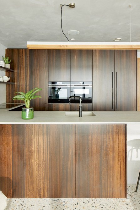 The smoked eucalyptus front kitchen; the textured ceilings and walls are created using Bauwerk lime paint.