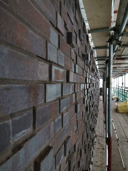 Staggered projecting bricks and variations in bond contribute to Gateway West’s textured brickwork pattern.