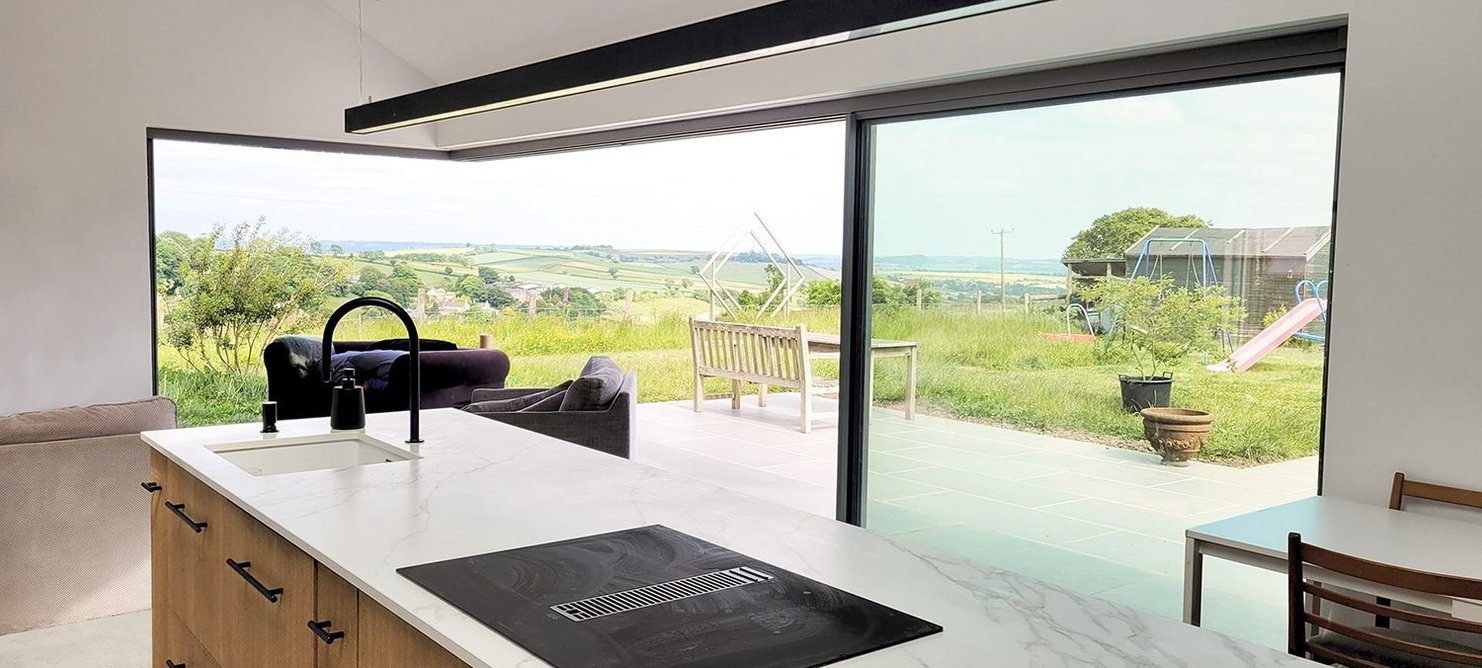 The living room takes full advantage of the volume of its pitched roof. And of the sweeping views.