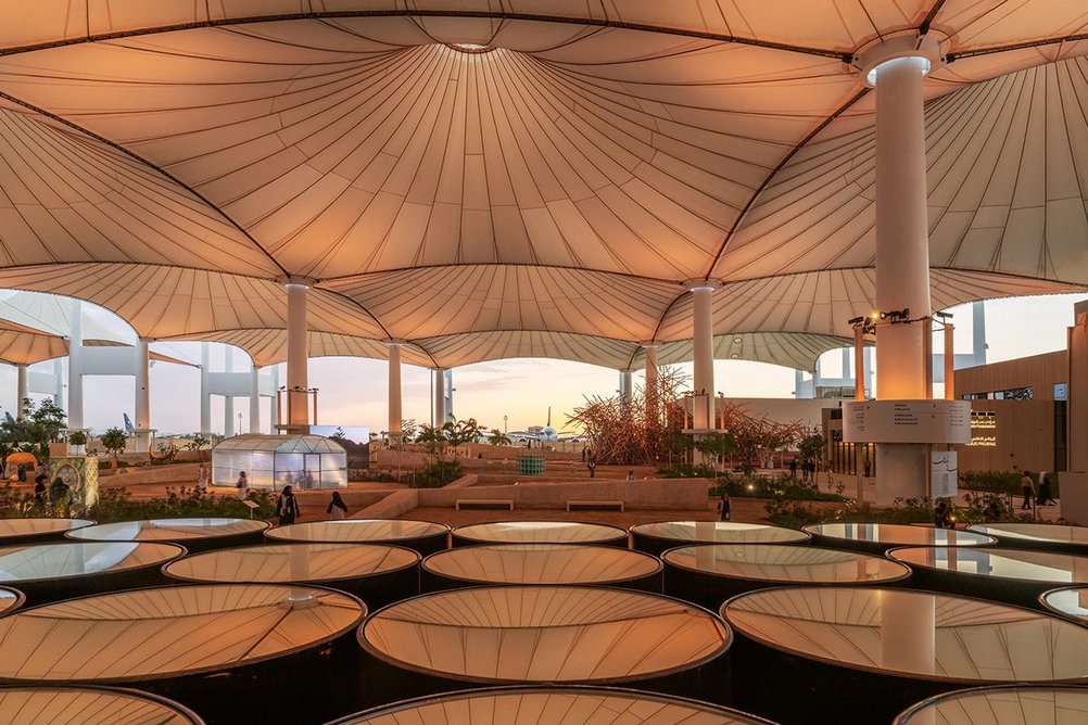 Barrels by artist Takashi Kuribayashi formed part of the AlMidallah section, under the fabric roof.