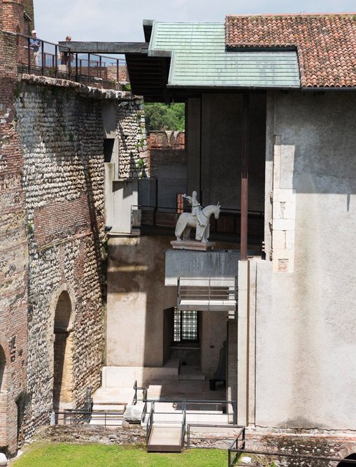 Castelvecchio's statue of the Can Grande on his horse displayed on a new pedestal under a new roof, next to the old Commune wall (left) creates a layered image of history.