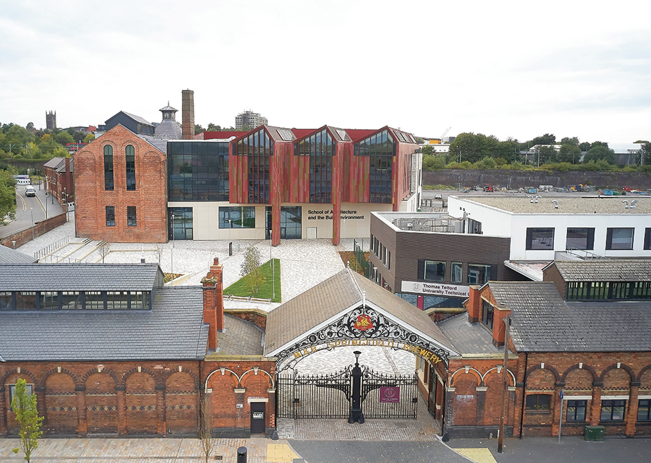 View west past the brewery gateway and stable blocks to the courtyard and new school. The train viaduct is behind with the tower of St Peter’s church in the distance.