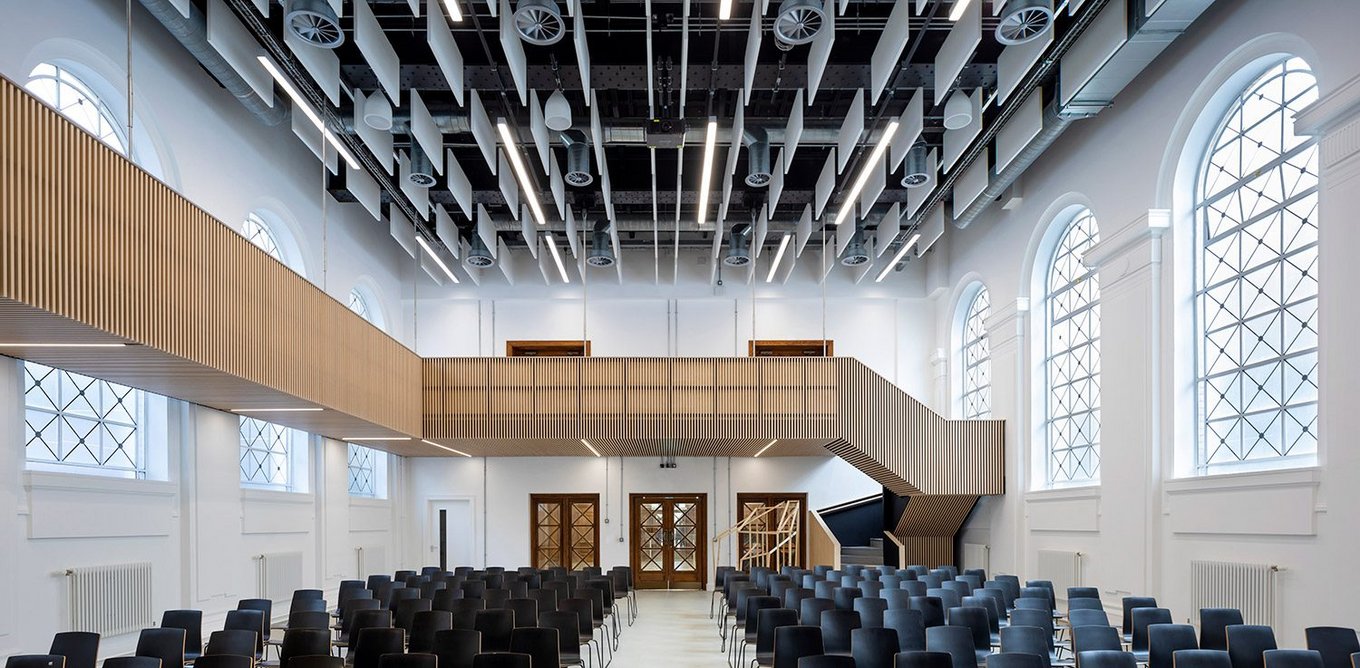 Despite the acoustic panels on the ceiling the assembly hall’s long windows and dimension gives it an ecclesiastical aura.