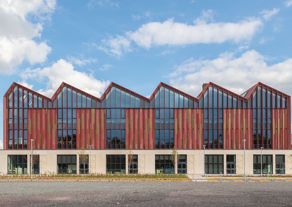 With an MMC aesthetic, the west elevation has repeating bays of precast concrete, vertical louvres and metal panels. The architecture studio runs below the length of the roof.