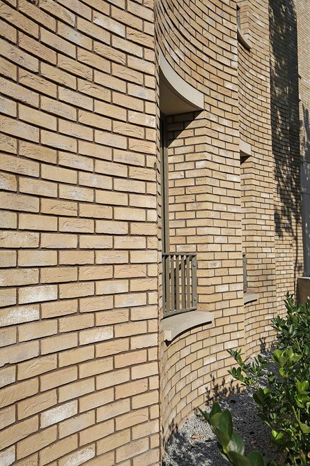 The brick specification harmonises with the concrete sills and copings.
