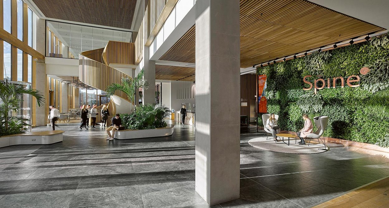 The reception area features a biophilic living wall.