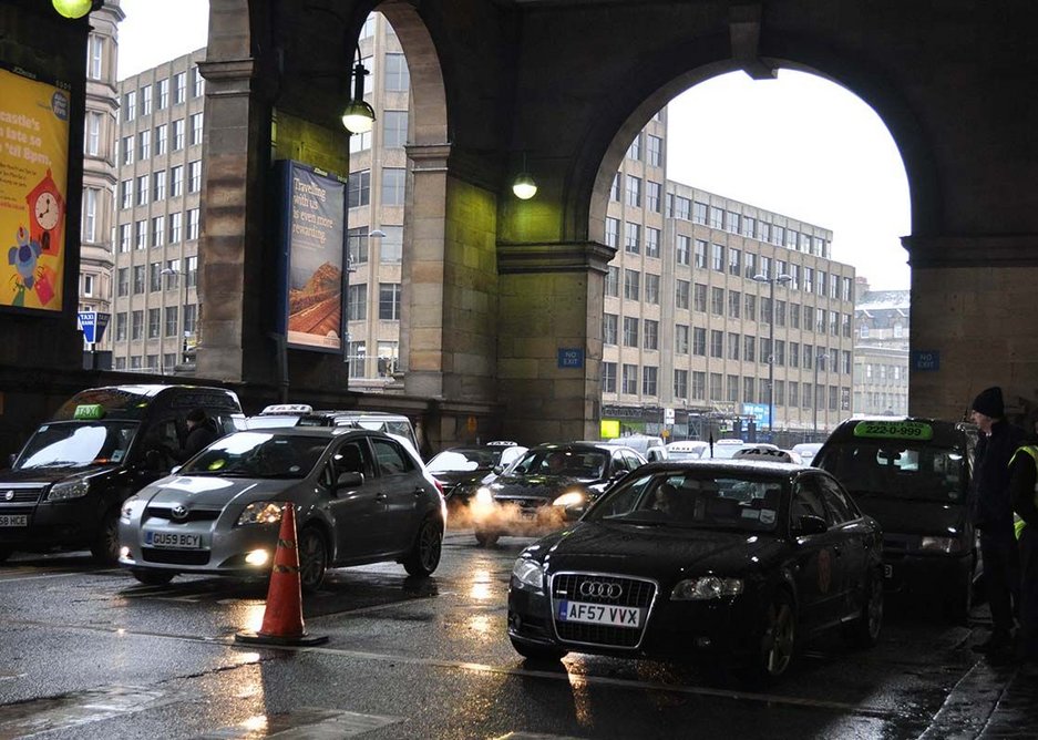 Under the Portico before the works: taxi rank and slow moving cars dropping passengers off, all exhausting their fumes into the Portico.