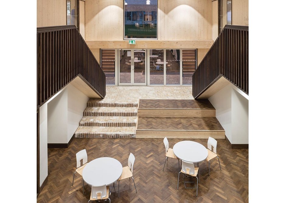 The classroom cluster around this generous central space that operates as relaxed library, circulation and extra work space. It opens up onto the grass on one side and, with sliding doors, a classroom on the other.