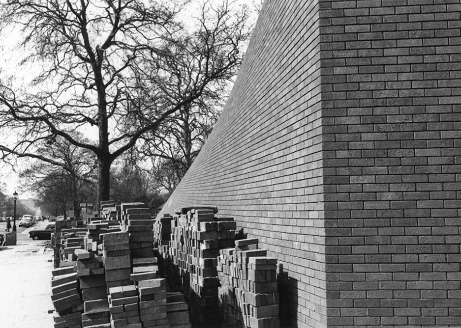 RCP construction works   The Wolfson Theatre was a huge engineering challenge for Lasdun’s team. It was designed with twists in its walls to align the building with Regent’s Park and the awkward angle of St Andrews Place.   37 different types of Baggeridge blue engineering bricks were needed to create this effect. Because cut surfaces of bricks have a different texture and colour to fired surfaces, these special bricks had to be hand-cut before they were fired.   Many were rejected as being the wrong texture or colour, and were carried away by Edward Cullinan, a young architect in Lasdun’s office. They were used to pave the floors of his homes in Camden and the North Staffordshire Moors.