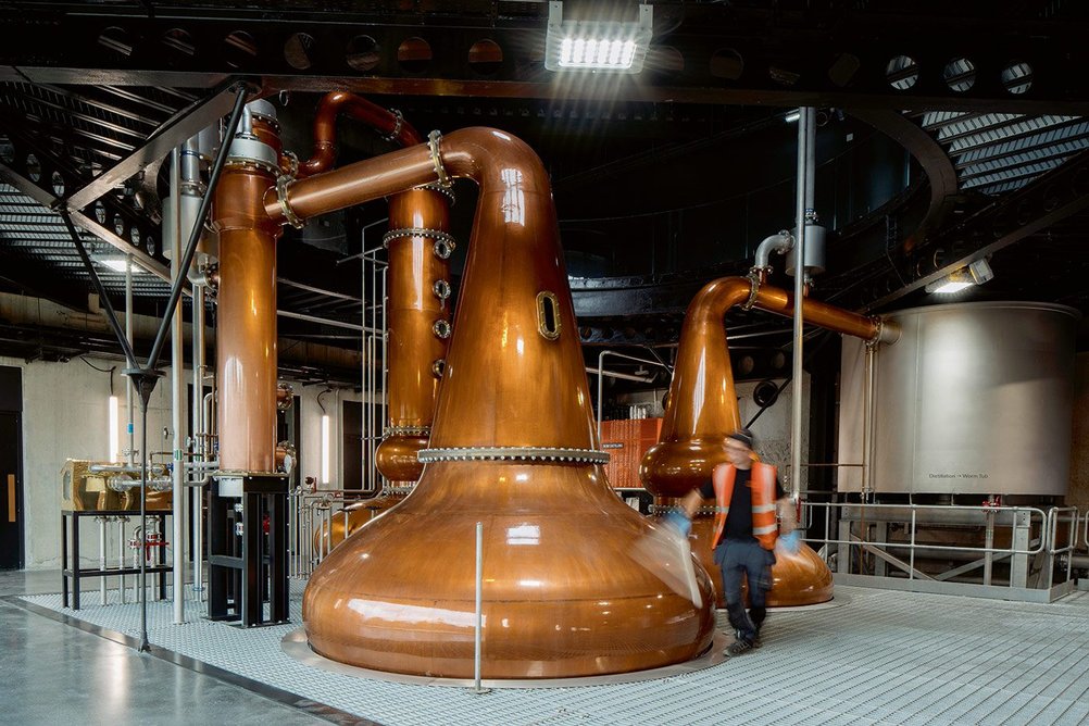 Hand-hammered copper pot stills echo the rust-coloured roofs.