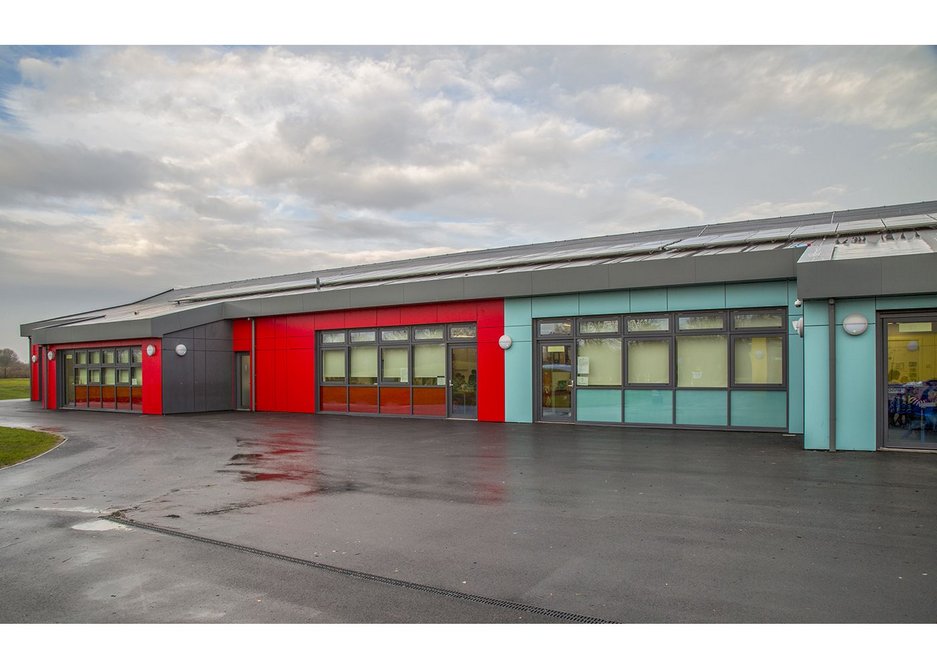 Red and blue Formica rainscreen panels at Barrow Hall Primary School near Warrington, designed by Ellis Williams Architects.