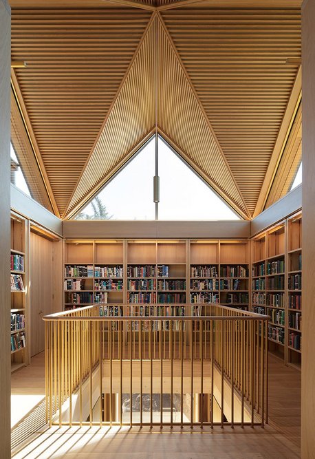 Cut-outs in the timber slabs create surprising and enjoyable moments on the upper level’s south side bookstacks.