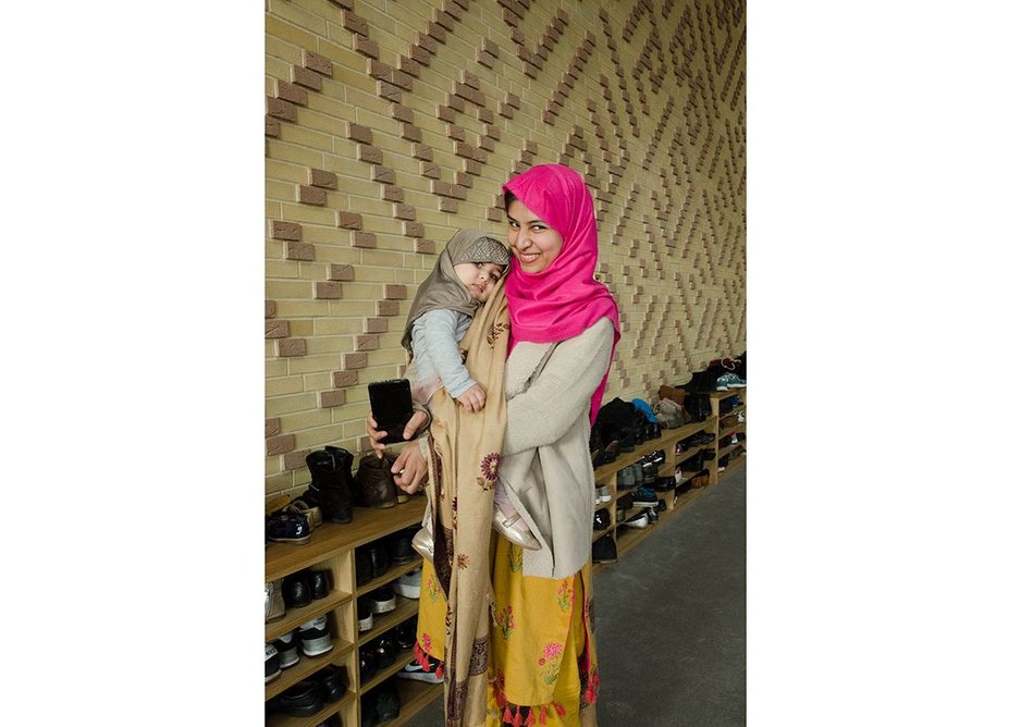 A mother and child outside the prayer hall.