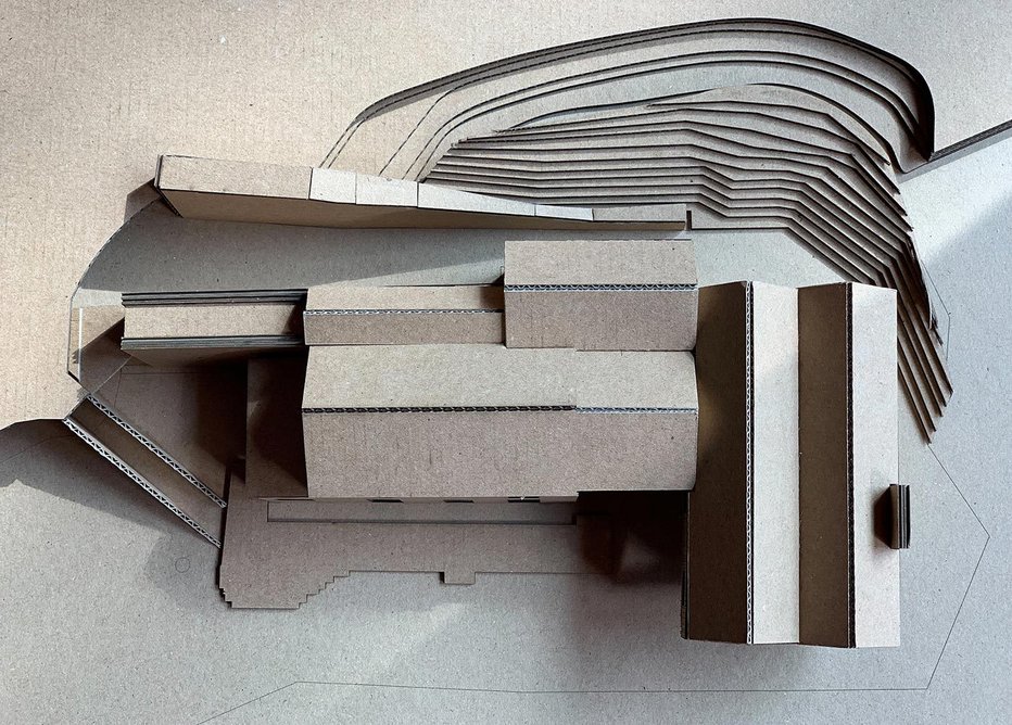 The model shows how the ground rises up behind the building.