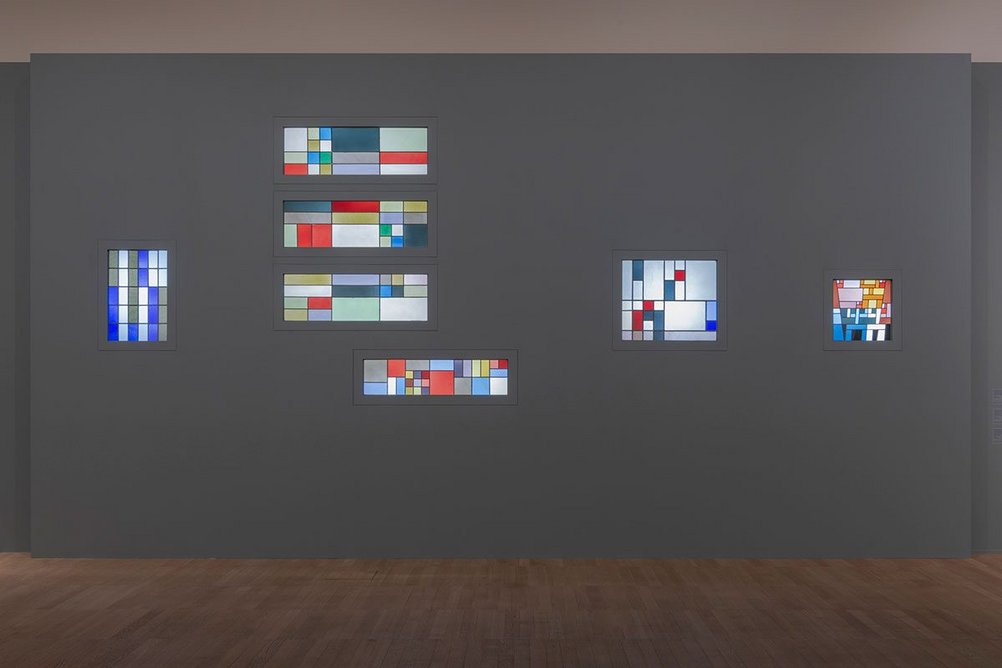 Installation image of the exhibition Sophie Taeuber-Arp showing stained glass windows designed by her for the home of the collector Andre Horn.
