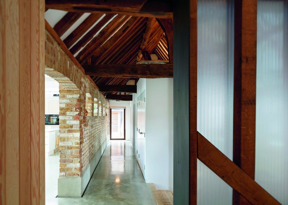 The stepped entrance area leads up to the dairy block’s concrete floor  and brick wall – and the kitchen space beyond.
