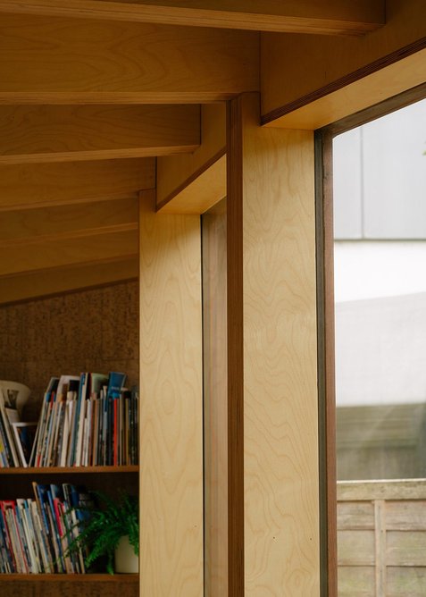 Detail of the curved facade and birch plywood roof structure.