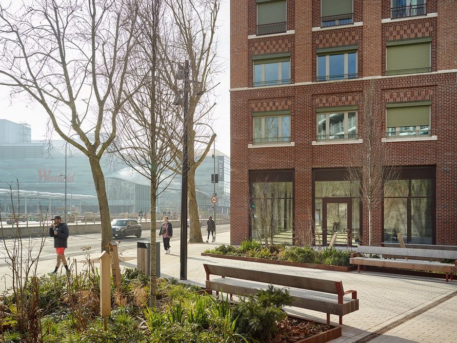 A public sitting area occupies the north of the site.