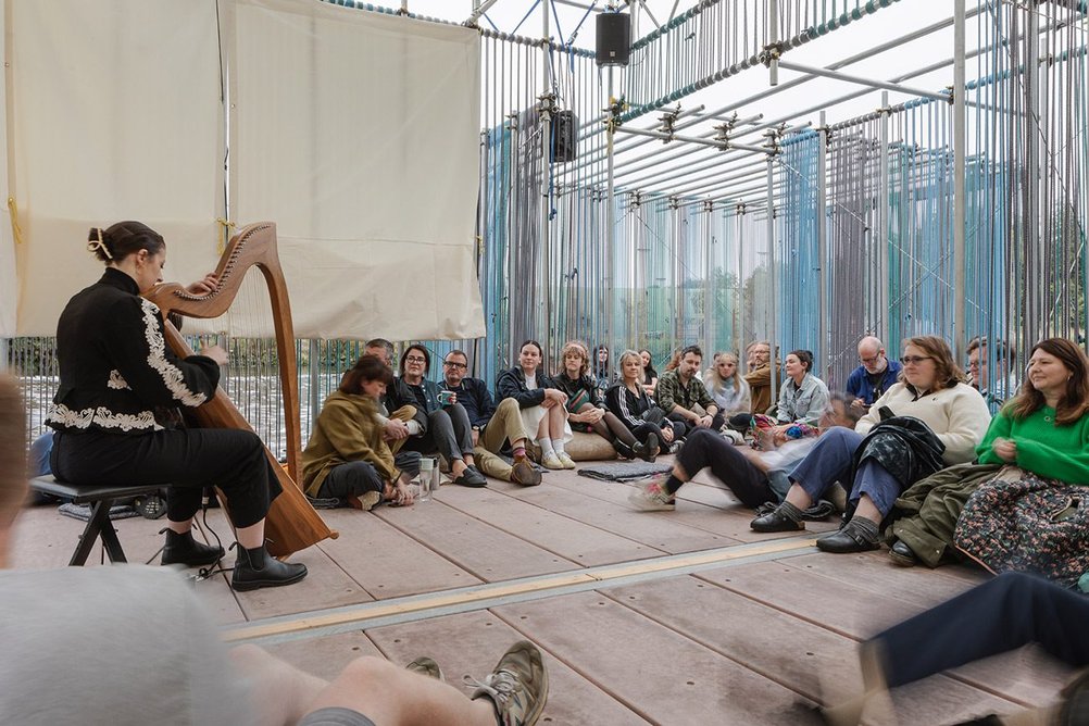 DRIFT, Belfast, by OGU Architects + MMAS + Matilde Meireles: Listening to harpist Gráinne Meyer at the DRIFT x Moving on Music event.