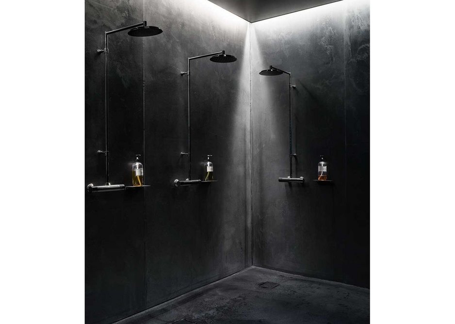 Black downlit concrete showers.