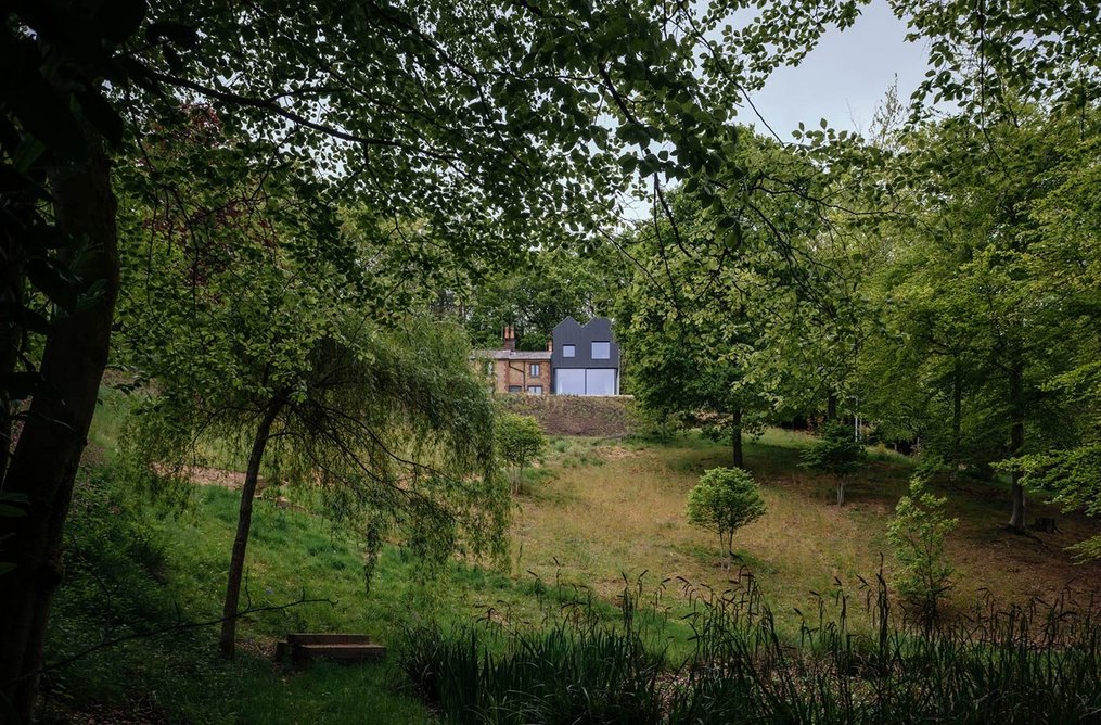 A double-pitched roof reduces the height and chimes with the roof form of the cottage.