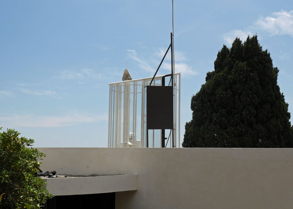 Glass spiral tower marks stair to roof.