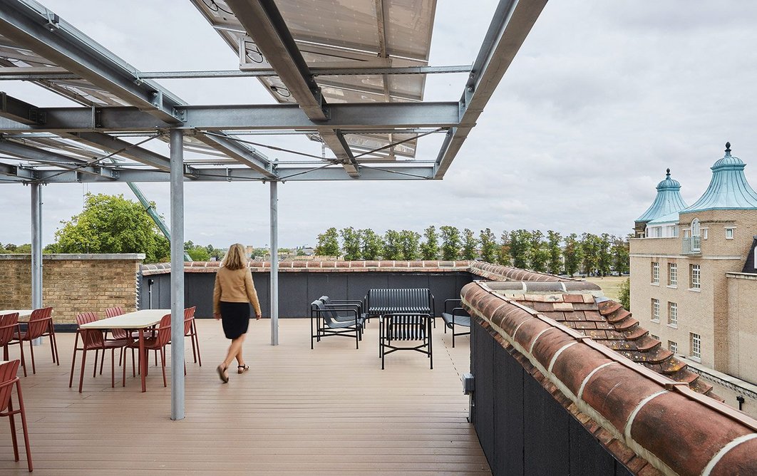 A repurposed steel frame supports PVs and provides shelter up on the new roof terrace.