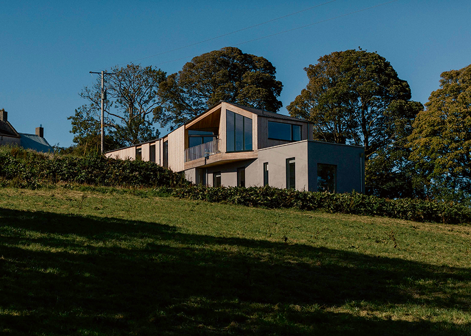With views over the Ring of Gullion, the plan of the house at Whitecross responds to the geometries and contours of the landscape with splaying walls and an upper level living space.