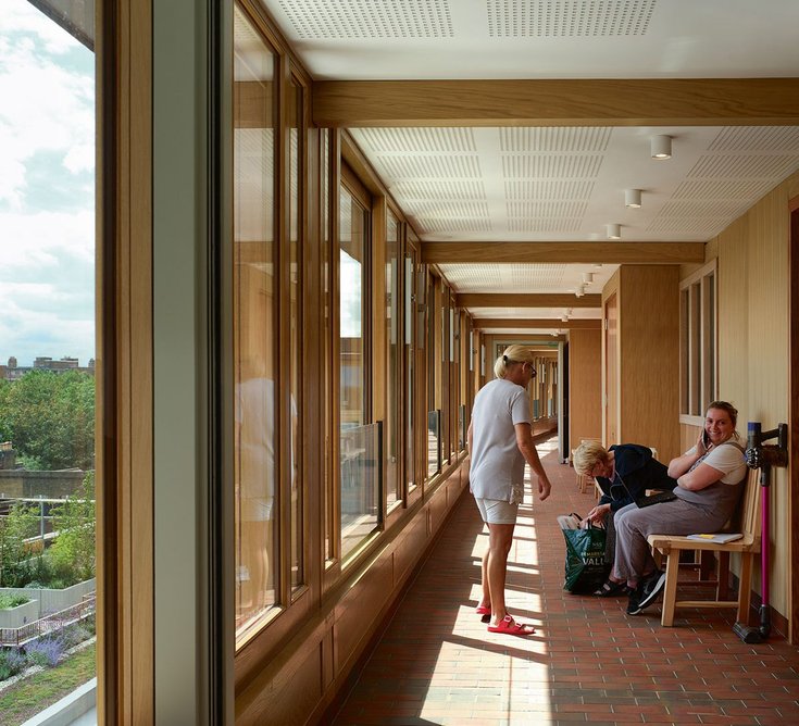 Benches outside kitchen windows on the wide walkways create immediate sociable space.