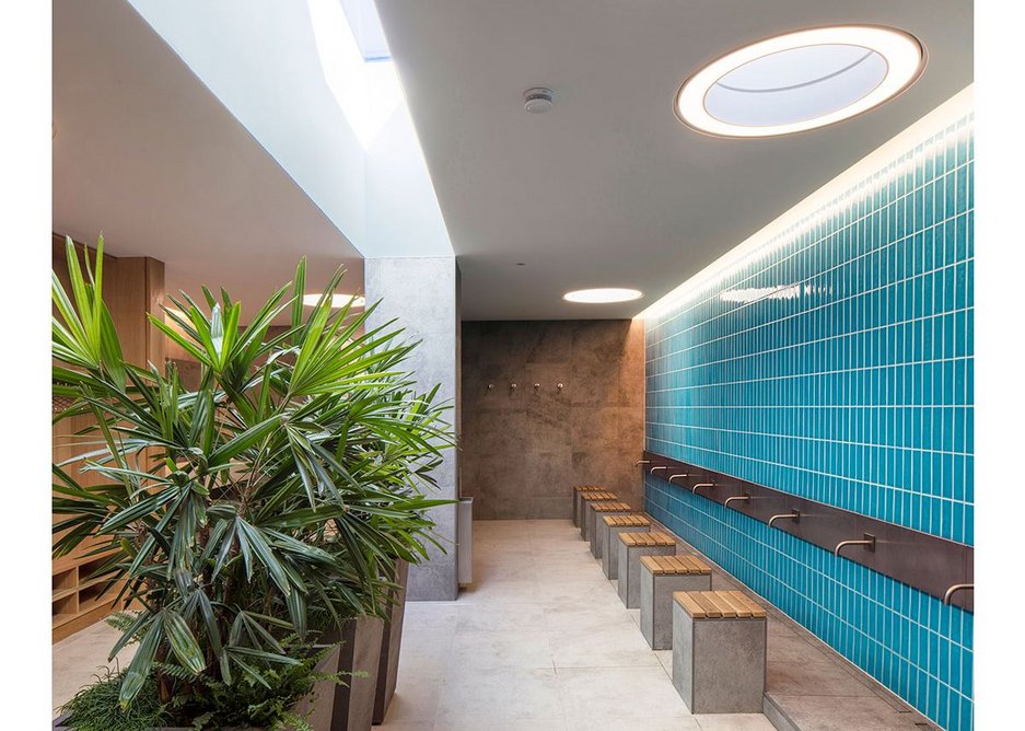 The male ablution space is bathed in natural light from above. The hot water is powered by PVs, and rainwater is harvested for flushing WCs.