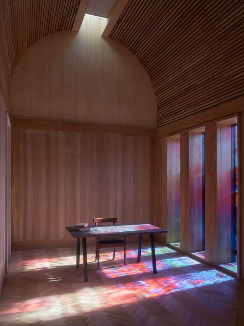 Jury/second court room at Westminster Coroner’s Court. Light streaming through the stained glass projects colour into the deliberately neutral tones of the interior. Photo: Andy Stagg