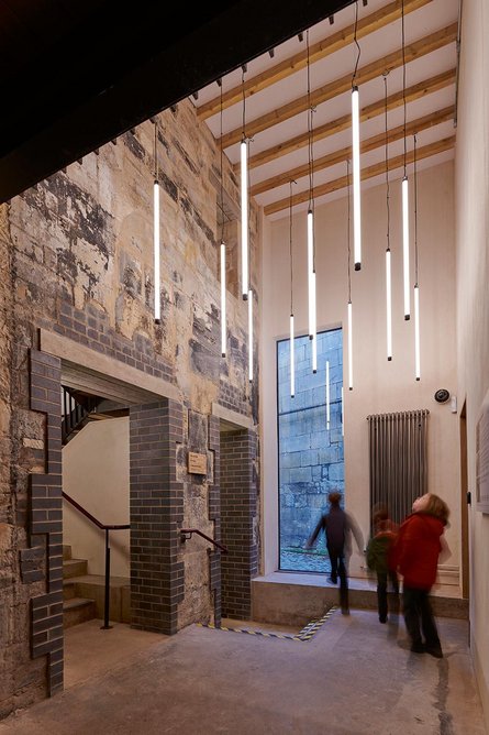 Scrape and reveal shows up complex textures in the entrance hall. From here visitors descend via a narrow stair and tunnel or ascend to the learning rooms above.