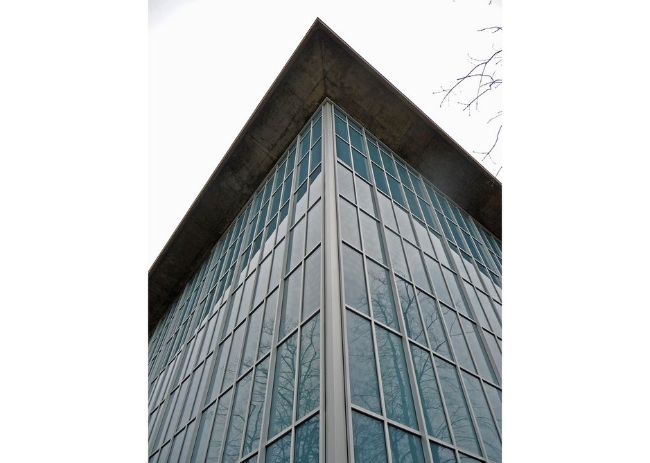 Replacement cladding in blue-grey glass is the building's second reclad since 1962.