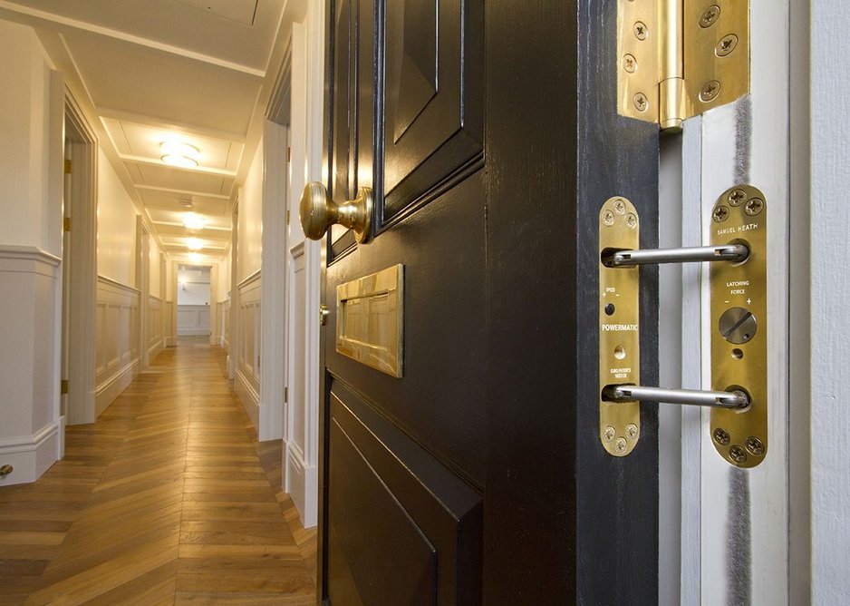 Samuel Heath polished brass door furniture and Powermatic concealed door closer at Leinster Square.