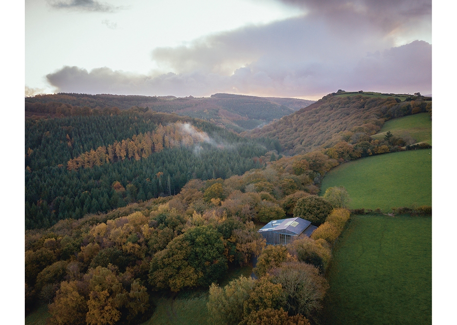 The track leading to the Art Barn enters a 100-acre broadleaf wood cloaking the north bank of the River Teign and arrives at the building’s gabled east facade.