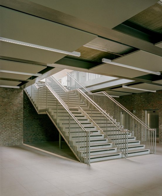 This image The steel and concrete stair also adopts  an industrial aesthetic.