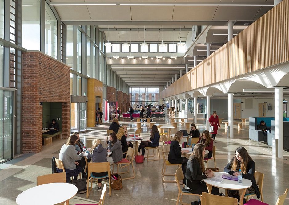 Main pavilion with mezzanine on the right and individual study pods defining the facade on the left.