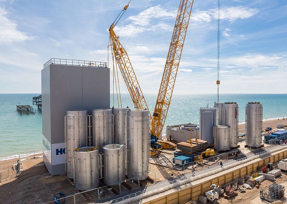 The tower under construction. The ‘can’ components arrived by barge before being stacked to form the tower.