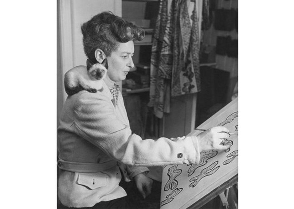 Enid Marx working on a textile design post-1945.