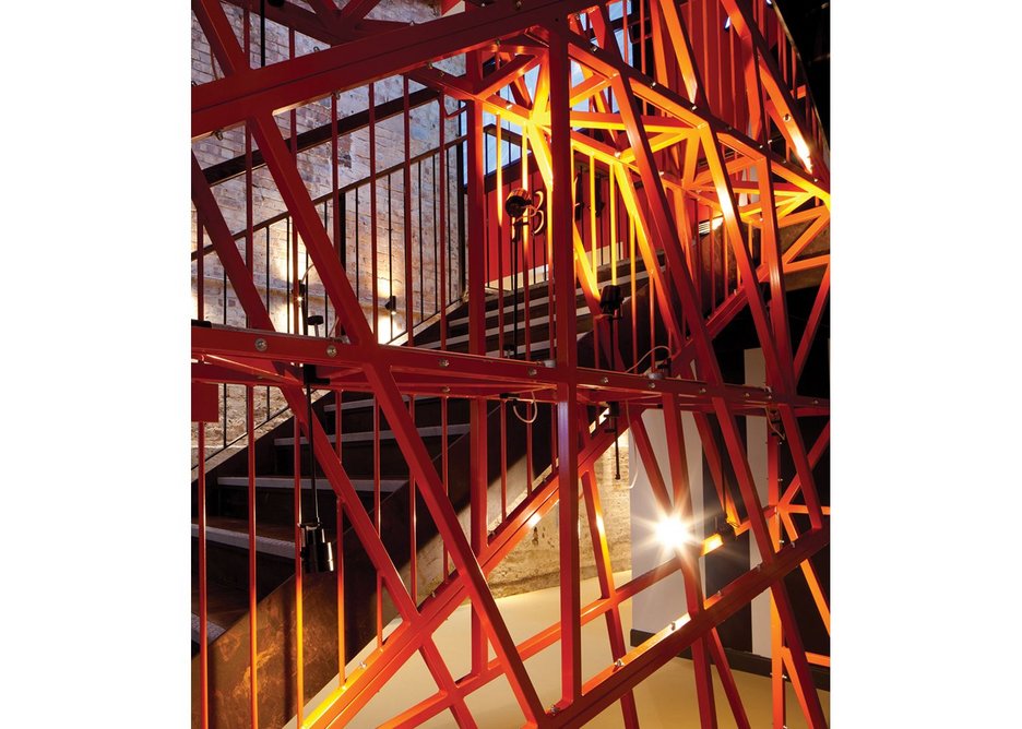 ... and a constructivist flavour to the orange-painted steel latticework staircase in the new atrium.