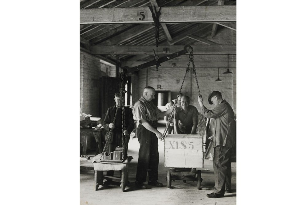 Tea chests being weighed using a beamscale, 1949.