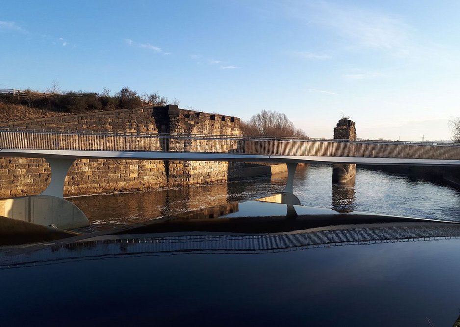 Old industry backdrops new bridge – visually it dissolves at a distance.