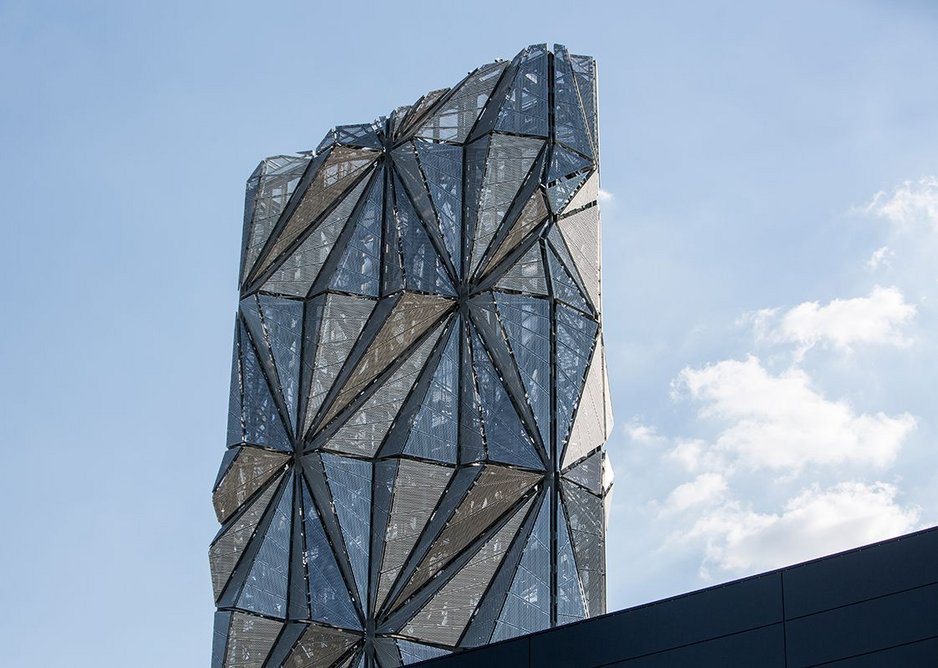 The mesh panels are angled to break up the surface of the chimney.