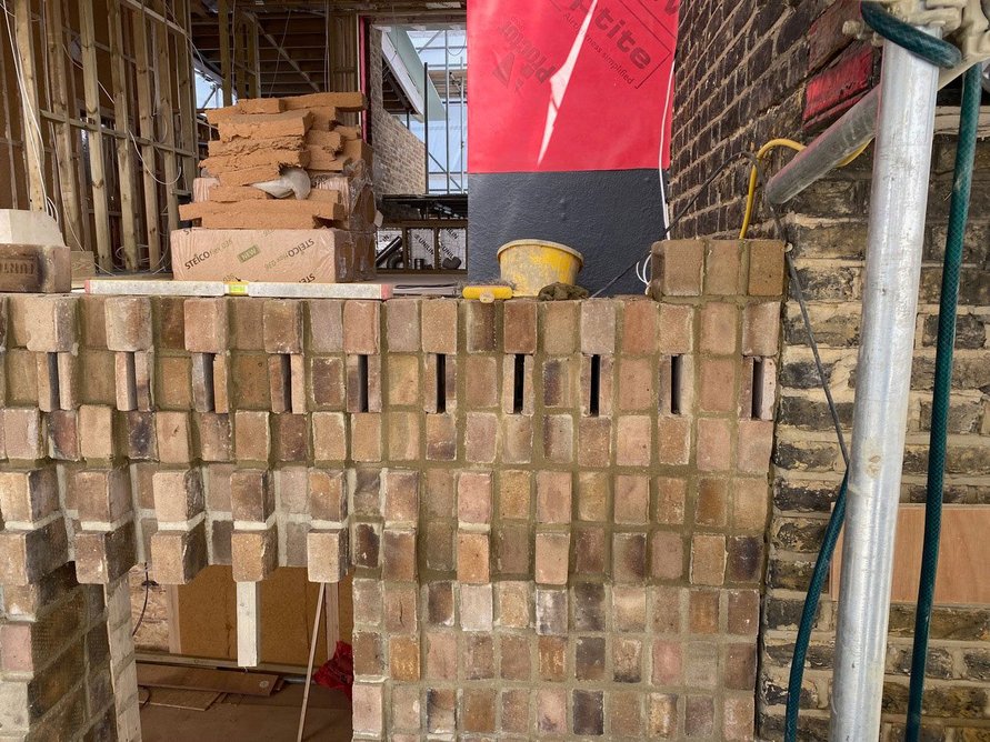 Corbelled brick facade under construction at Knox Bhavan’s ongoing House in Peckham. Bricks were modified by Everything Now Design.